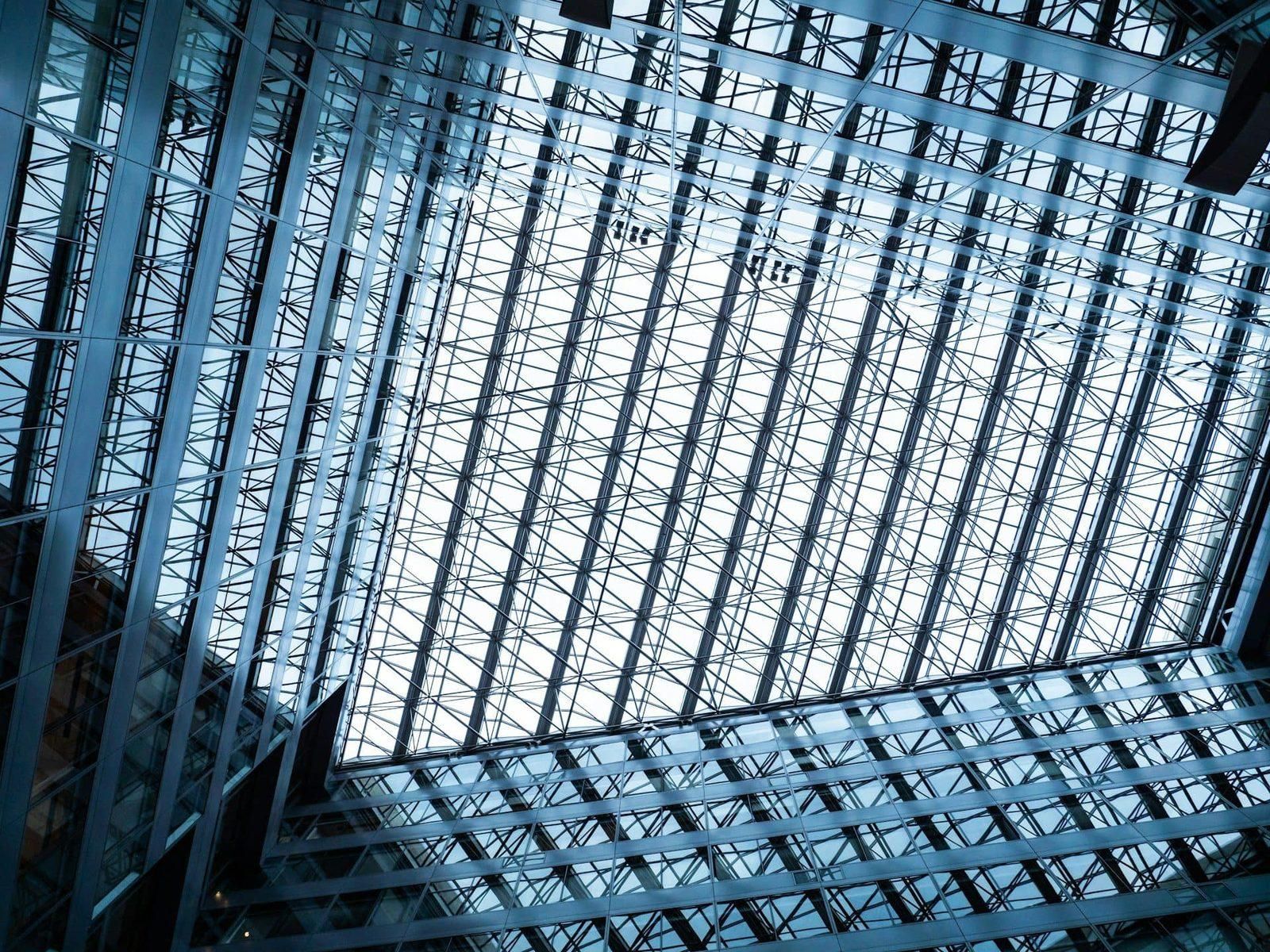 Class A office building lobby atrium with floor-to-ceiling glass and polished stone floors